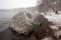 Photographer, Peter Cairns' floating hide in blizzard, Loch Insh, Cairngorms NP, Highlands, Scotland, UK, March 2011. 2020VISION Exhibition.
