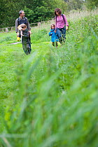 Family going pond dipping on visit to the Westhay Nature Reserve, Somerset Levels, UK, June 2011, model released