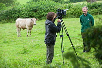Camerman Will Bolton filming on Tealham Moor discussing the Conservation grazing programme with Somerset Wildlife Trust officer, David Leach, Somerset Levels, UK, June 2011