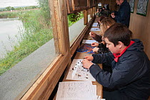 Children from Robert Blake Science College learning about environmental issues at Westhay Nature Reserve, Somerset Levels, UK, June 2011, model released