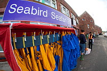 Waterproof clothing for tourists taking zodiac boat on seabird safari tour around Bass Rock, North Berwick, Firth of Forth, Lothian, Scotland, UK, August 2011
