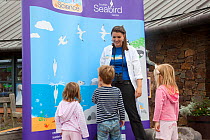 Children being educated about Gannets at Scottish Seabird Centre, North Berwick, Firth of Forth, Lothian, Scotland, UK, August 2011
