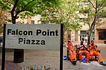 Workmen resting beside sign'Falcon Point Piazza' for the RSPB 'Date With Nature Event' for learning about urban Peregrine falcon, Tate Modern, South Bank, London, UK, September 2011, RSPB Greater Tham...