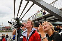 RSPB staff member Emma Cambell showing peregrines to young woman at RSPB 'Date With Nature Event' for learning about urban Peregrine falcon, Tate Modern, South Bank, London, UK, September 2011, RSPB G...