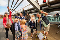 Children Charlie and Amelia Freeman and Oliver and Amber Williams with mothers D Williams and Lisa Freeman watch peregrines through telescopes. RSPB 'Date With Nature Event' for learning about urban P...