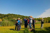Birdwatchers watching Red Kite in the Urban Red Kite area of the Derwent Valley, Gateshead, Tyne and Wear, UK, on the edge of Tyneside following on from the 'Northern Kites' re-introduction programme...