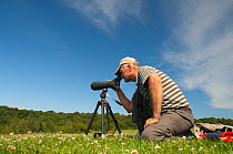 Birdwatcher watching Red Kite in the Urban Red Kite area of the Derwent Valley, Gateshead, Tyne and Wear, UK, on the edge of Tyneside following on from the 'Northern Kites' re-introduction programme b...