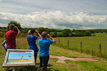 Birdwatchers and information sign on the Red Kite trail in the Urban Red Kite area of the Derwent Valley, Gateshead, Tyne and Wear, UK, on the edge of Tyneside following on from the 'Northern Kites' r...