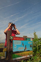 Birdwatcher and information sign on the Red Kite trail in the Urban Red Kite area of the Derwent Valley, Gateshead, Tyne and Wear, UK, on the edge of Tyneside following on from the 'Northern Kites' re...