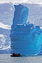 Tourists in zodiac looking at icebergs. Antarctic Peninsula, January.
