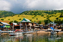Boats and houses on the coast of Komodo Island. Republic of Indonesia, Southeast Asia.