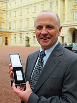 Doug Allan receives the second bar of The Polar Medal at Buckingham Palace, London, UK, 26th January 2012. Doug received his first Polar Medal in 1983 for his work with the British Antarctic Survey.
