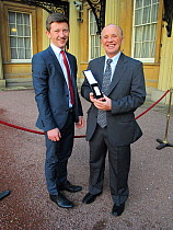 Doug Allan with his son, Liam, receiving the second bar of The Polar Medal, Buckingham Palace, London, UK, 26th January 2012. Doug received his first Polar Medal in 1983 for his work with the British...