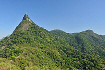 Corcovado Hill with the statue of Christ, the Redeemer, and the Atlantic rainforest of Tijuca National Park, in Rio de Janeiro City, Rio de Janeiro State, Brazil.