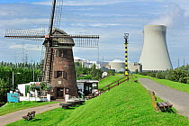 The windmill Scheldedijkmolen and cooling towers of the Doel Nuclear Power Station along the river Scheldt at Kieldrecht / Beveren, Belgium