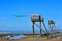 Traditional carrelet fishing huts with lift net on the beach at Saint-Michel-Chef-Chef, Loire-Atlantique, France September 2011
