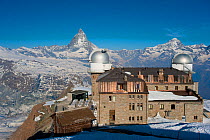 Gornergrat Station with observatory domes, Monte Rosa and Cervino (The Matterhorn) massif on the horizon, Pennine Alps, Switzerland, April 2011.