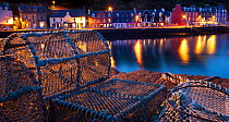 Lobster pots on harbourside at night, Tobermory harbour, Isle of Mull, Scotland.