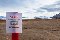 Sign warning of danger of Polar bears, Ny-Alesund International Research village, Spitzbergen, Svalbard, Norway, July 2011  /   Panneau d'avertissement de danger en raison de la presence possible d'o...