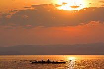 Fishermen on Lake Kivu at dawn, using traditional fishing rods and paraffin lights. Democratic Republic of Congo, August 2010