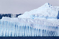 Large grounded iceberg with grooved vertical channels. Half Moon Island, Antarctic Peninsula, Antarctica, December.