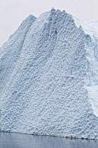 Large iceberg with scalloping on the face. Paradise Bay, Antarctic Peninsula, Antarctica, December.