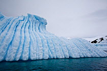 Iceberg with vertical eroded channels. Cuverville Island, Antarctic Peninsula, Antarctica, December.