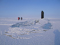 Submarine surfacing through ice sheet. Beaufort Sea, Alaska, USA, March. Freeze frame book plate page 131.