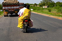 Indian family travelling on motor bike with shopping, Madhya Pradesh, India, 2006