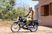 Forest park guard on motorbike, Pench National Park, Madhya Pradesh, India, 2006