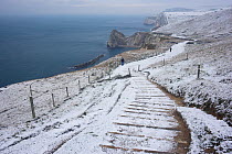 View along the snow covered coastline between Lulworth Cove and Durdle Door in the distance, Dorest, UK, November 2010