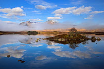 Rare combination of clouds, mirror reflections and mist slowly clearing the Mountains on Loch na h Achlaise, Glen Coe, Rannoch Moor, Highland, Scotland, UK, April 2011