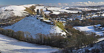 View of Corfe Castle and village in winter snow, Dorset, UK, December 2010