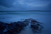 Long exposure of sea with rock formations in the foreground, Horgabost, Isle of Harris, Outer Hebrides, Scotland, UK, October 2011