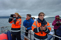 Sea Life Surveys guides and tourists on a wildlife watching cruise, Sound of Mull, Inner Hebrides, Scotland, UK, July 2011