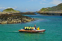 Tourists on board an inflatable boat, Cairns of Coll, Inner Hebrides, Scotland, UK, July 2011