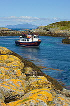Wildlife watching tourists on the observation deck of Sea Life Surveys boat Sula Beag at the Cairns of Coll, Inner Hebrides, Scotland, UK, July 2011