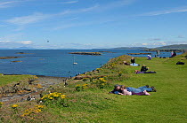 Tourists watching Atlantic puffins (Fratercula arctica) at their breeding colony on Lunga, Inner Hebrides, Scotland, UK, July 2011