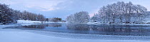 Panoramic of partially frozen River Spey with frosted trees at dusk in winter, Cairngorms NP, Scotland, UK, December 2012