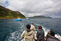 Tourists on a boat trip to watch White-tailed sea eagles, near Skye, Inner Hebrides, Scotland, UK, June 2011