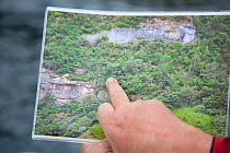 Hand pointing out location of sea eagle nest to a tourist, Portree, Skye, Inner Hebrides, Scotland, UK, July 2011