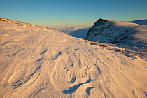 Sastrugi (irregular grooves and shapes in snow caused by wind erosion and deposition) on Ben More Coigach in winter, Coigach, Wester Ross, Scotland, UK, December 2010