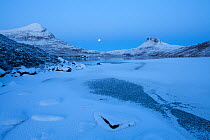 Sgurr Tuath and Stac Pollaidh at dawn, with frozen Loch Lurgainn in foreground, Coigach, Wester Ross, Scotland, UK, December 2010