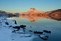 Stac Pollaidh at dawn with Loch Lurgainn in foreground, Coigach, Wester Ross, Scotland, UK, December 2010