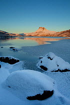 Stac Pollaidh at dawn with partly frozen Loch Lurgainn in foreground, Coigach, Wester Ross, Scotland, UK, December 2010