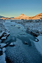 Stac Pollaidh at dawn with frozen water in foreground, Coigach, Wester Ross, Scotland, UK, December 2010