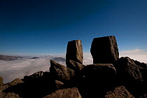View from the summit of Tryfan over temperature inversion clouds, with summit rocks Adam and Eve in the foreground, Snowdonia NP, Gwynedd, Wales, UK, March