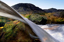 A split-level view through a small waterfall, Llanberis, Snowdonia NP, Gwynedd, Wales, UK, July
