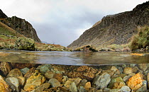 A split-level image of Afon Nant Peris,a small mountain stream, and the Llanberis Pass, Snowdonia NP, Gwynedd, Wales, UK, December