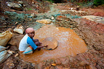Woman gold mining near Daraine, a threat to the natural habitat of Tattersalli / Golden crowned sifaka (Propithecus tattersalli), Madagascar, November 2011